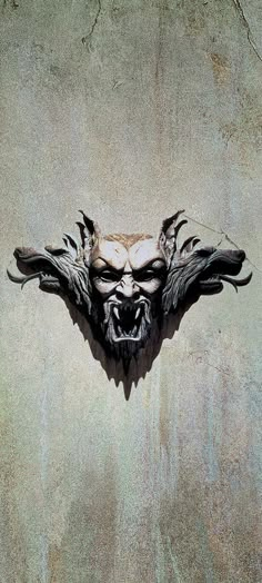 the face of an evil demon is shown in this artistic photo, which appears to be made out of concrete