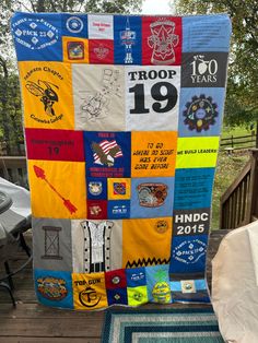 a quilt made to look like it has been placed on a deck with other items