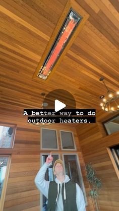 a man standing in front of a window with the words a better way to do outdoor heaters