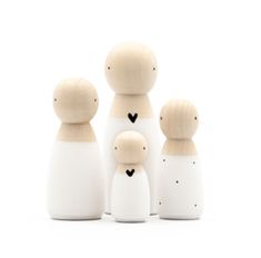 a group of wooden dolls standing next to each other on a white background with the word love written in gold