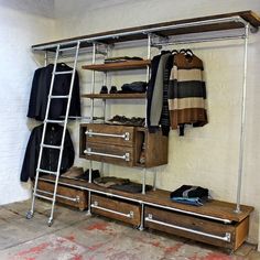 an industrial style clothing rack with drawers and shelves