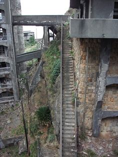 an abandoned building with stairs leading up to the top