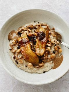 a bowl filled with oatmeal topped with bananas and nuts