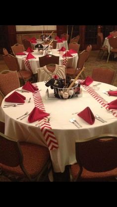 the table is set with red and white napkins, silverware, and candy canes