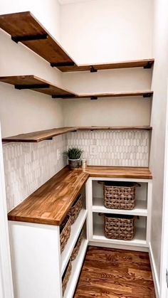 an empty walk in closet with shelves and baskets