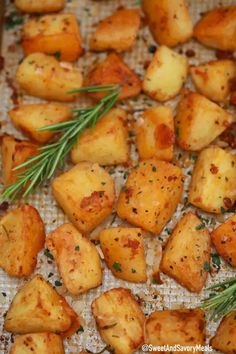 roasted potatoes with herbs and seasoning on a baking sheet