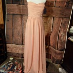 a dress on display in front of a wooden wall