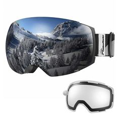 a pair of ski goggles sitting on top of a snow covered mountain with trees