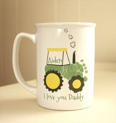 a white coffee mug with a tractor on the front and i love you daddy written on it