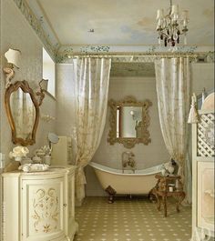 a bathroom with a tub, mirror and chandelier on the wall in it