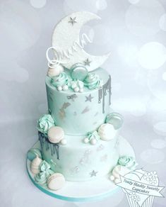 a three tiered cake decorated with stars and moon