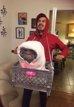 a man in a red hoodie holding a basket with a stuffed animal inside