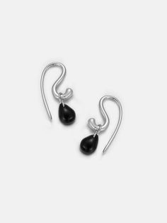 Experience the unique versatility of our Black Onyx Hook Earrings. Crafted from eco-conscious 925 sterling silver, these earrings boast a hook design that offers multiple wearing options, tailored to your ever-changing style needs. The detachable black onyx droplets add a bold pop of color and elegance to any ensemble. Wear them together for a classic look or separate for a more modern, minimalist approach. Let our hook earrings boldly elevate your personal style sustainably. Details Recycled Si Modern Black Sterling Silver Earrings, Everyday Black Sterling Silver Earrings, Modern Onyx Drop Earrings, Sterling Silver Black Enamel Drop Earrings, Black Enamel Sterling Silver Drop Earrings, Sterling Silver Drop Earrings With Black Enamel, Elegant Black French Hook Earrings, Black Drop Earrings With French Hook, Black Sterling Silver Long Drop Jewelry