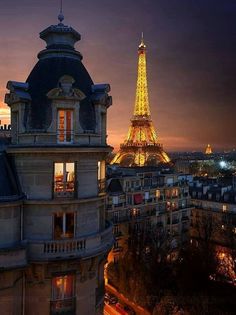 the eiffel tower is lit up at night