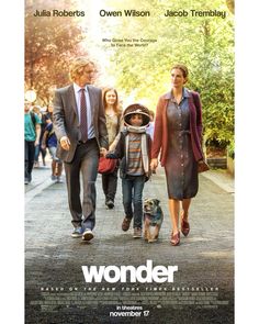 a movie poster for the film wonder with two adults and a child walking down a street