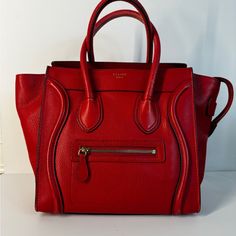 Celine Micro Luggage Handbag Red There Is Some Discoloration On The Handle And Corner Of The Bag. Luxury Red Satchel For Daily Use, Designer Red Shoulder Bag For Travel, Designer Red Tote Bag, Red Textured Leather Tote Bag, Designer Red Textured Leather Bag, Red Textured Leather Bag For Daily Use, Designer Red Tote Satchel, Designer Red Bags With Handles, Red Travel Bags With Gold-tone Hardware