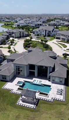 an aerial view of a large house and pool