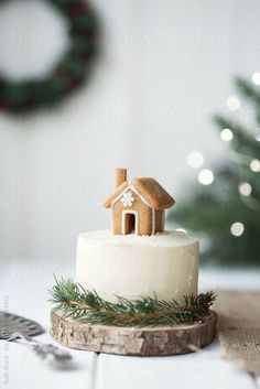 a small white cake with a house on top