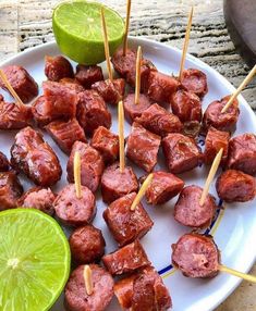 skewered meat and lime on a plate with toothpicks