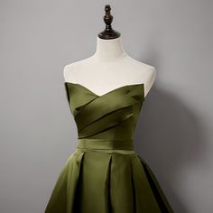 a green dress on a mannequin dummy