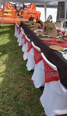 a long table set up with red and white cloths for an event or party