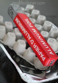 a red and white toothbrush sitting on top of an egg carton filled with eggs