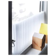 a wooden block sitting on top of a window sill