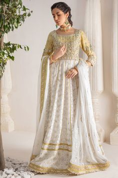 A contemporary Classic - Over a canvas of Pure chikankari chiffon, features a beautiful floral embroidered bodice further enhanced with dabka, sequins, pearls and kundan work. This classy peshwas is paired with gorgeous kamdani work dupatta, making this an absolute favorite for nikkah, engagement & other celebratory festivities Hand crafted tassels & straight pant completes the look of this outfit. Peshwas Fabric: Pure Chiffon Peshwas Length: 60” (customisable, mention in order notes) Sleeve length: 16” Pant Fabric: Khaadi Silk Dupatta Fabric: Georgette Chiffon Color: Ivory & Gold This outfit is fully lined, neck key-hole can be lined on request, mention in order notes. Please refer Size Guide Before selecting size For Customised measurements please select Custom size for an additional 20$ Kamdani Work, Kundan Work, Designer Outfit, Embroidered Bodice, Pure Chiffon, Contemporary Classic, Pakistani Designers, Silk Dupatta, Key Hole