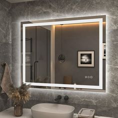 a bathroom with a sink, mirror and lights on the wall above it's counter