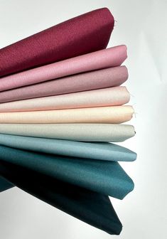 a stack of different colored fabrics on top of each other