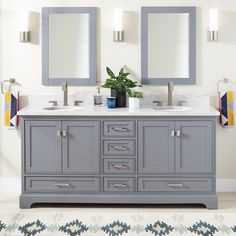 a bathroom vanity with two mirrors above it