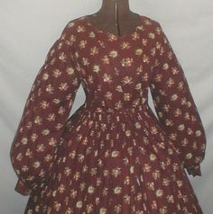 1860's Brown Floral Print Cotton Dress | eBay seller fiddybee; worn by member of Comb's family (name hand printed on inside of bodice) bell-shaped sleeves, piping at neck, dress all hand stitched, bodice lined with home spun linen, no hooks & eyes on front, skirt attached to waist w/ cartridge pleating, skirt unlined, period mend gussets under each arm using same fabric, bust: 35: waist: 32, skirt length: 39"; width at hem: 106". Floral Print Cotton Dress, Edwardian Era Fashion, Brown Floral Print, Dresses Outfits