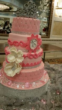 a three tiered pink and silver wedding cake