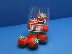 three strawberries in a plastic bag on a blue surface