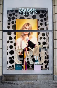 a window display with the words color crush in front of it