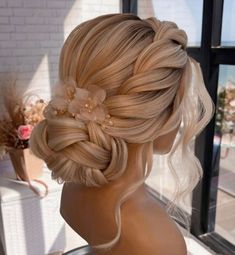 a woman with blonde hair and flowers in her hair is looking out the window at something outside