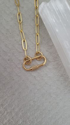 "Mini lock necklace - heavy 16k gold plated over brass - 16\" + 2\" extension - screw charm about 3/4\" long and 1/2\" wide (please see photo for exact mm) - ☆ the inner diameter of the rings/circle that slide into the Carabiner are 5mm, if you would like a larger size ring or specific mm message me your request ☆ Style option to purchase the necklace as pictured or the Carabiner only ♡ for the minimalist style person or everyday layer gal ◇ Another mini Carabiner option here https://www.etsy.com/listing/795710907/mini-carabiner-necklace-screw-necklace?ref=shop_home_active_1 * If you would like a different length of chain can select \"carabiner only\" and purchase your desired chain length seperate here ⬇️ https://www.etsy.com/listing/773867462/carabiner-chain-paperclip-chain?ref=shop_home Minimalist Gold Necklace With Hooks And Links, Gold Paperclip Necklace With Hooks And Links, Gold Chain Link Necklace With Carabiner Clasp, Carabiner Necklace, Necklace Lock, Lock Necklace, Unusual Jewelry, Circle Ring, The Rings