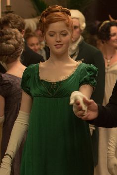 a woman in a green dress and white gloves