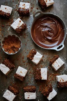 there are several pieces of cake that have been cut into squares and spread with chocolate