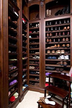 the closet is filled with many pairs of shoes