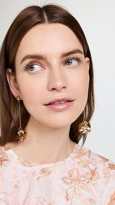 SHASHI Petunia Earrings | Shopbop Party Jewelry With Flower Charm Drop Earrings, Modern Flower Earrings For Pierced Ears, Feminine Dangle Flower Earrings, Metal Flower Earrings With Flower Charm, Gold Plated Single Dangle Flower Earring, Teardrop Earrings With Flower Charm, Brass Dangle Flower Earrings, Chic Dangle Flower Earrings For Pierced Ears, Chic Flower Charm Drop Earrings