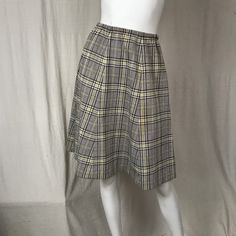 "This is a great midi skirt with a houndstooth pattern. The fabric is mid-weight polyester and the colors are fun. The waist is elastic. It's constructed of 6 panels, thoughtfully fitted. Details Size: unmarked Waist: 24\" - 32\" Hips: 42\" Length: 28\" Brand: unmarked Colors: Brown, Yellow & White Condition: Excellent, no issues." Knee-length Skirt For Fall Daywear, Knee-length Fall Skirt For Daywear, Knee-length Skirt For Daywear In Fall, Retro Knee-length Fall Skirt, Retro Knee-length Skirt For Fall, Retro Skirted Bottoms For Fall, Retro A-line Workwear Bottoms, Retro Fall Workwear Skirt, Retro Lined Skirt For Fall