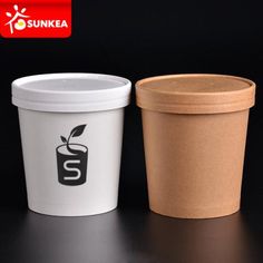 two different types of coffee cups sitting next to each other on a black table top