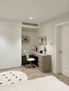 a bedroom with a bed, desk and chair in the corner next to a closet