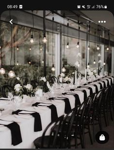 a long table is set with black and white linens