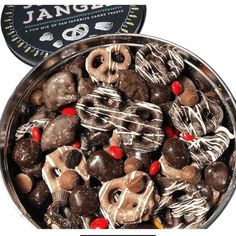 a tin filled with chocolate covered pretzels and candy