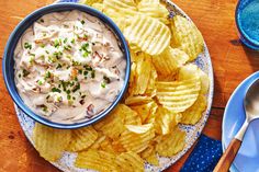 a bowl of dip and chips on a plate