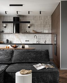 a living room filled with furniture next to a kitchen