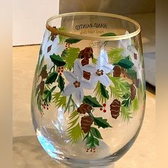 a hand painted wine glass sitting on top of a counter