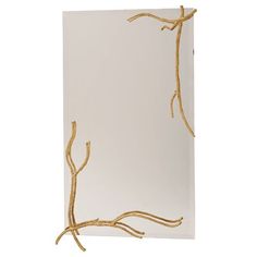 a white card with gold branches on it